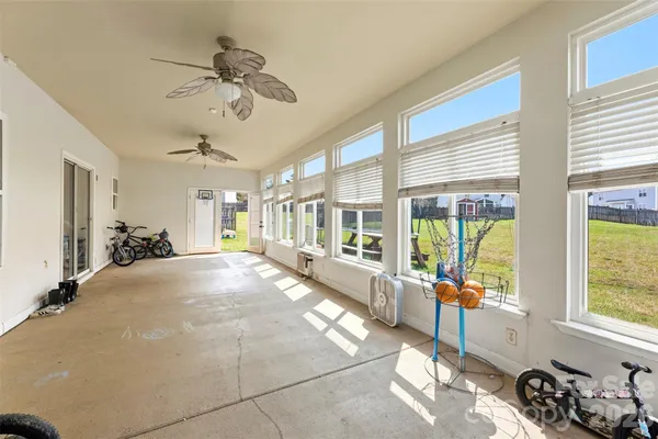 a spacious bedroom with a large bed and a chandelier