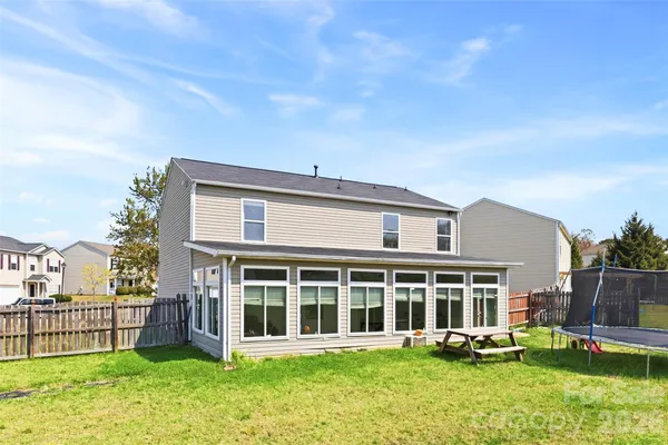 a view of a house with a yard and sitting area