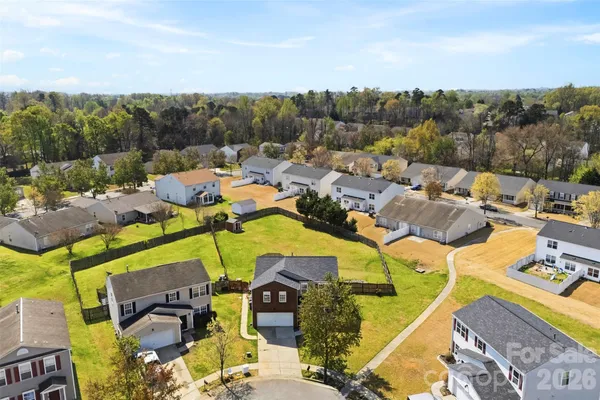 an aerial view of a house with a swimming pool