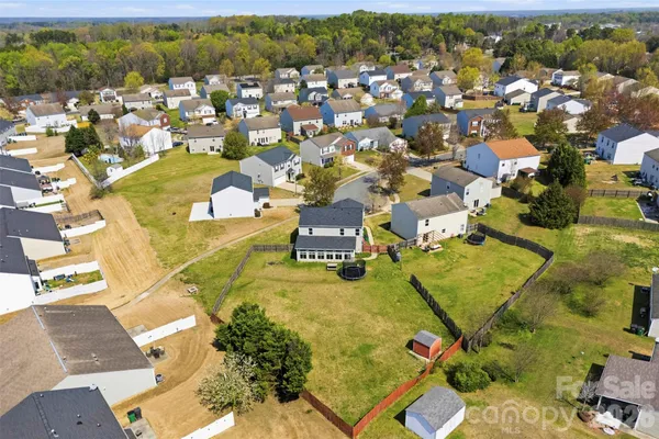 an aerial view of residential houses with outdoor space