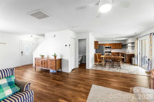 a living room with furniture and wooden floor
