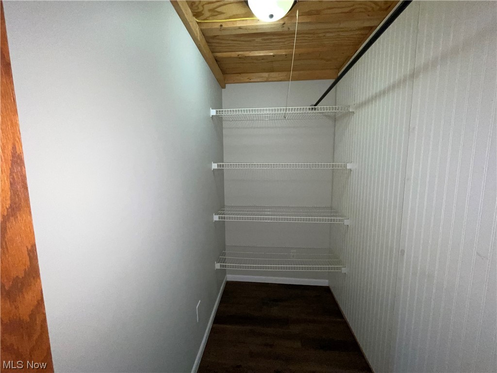 7114 Risden Road Vermilion, OH 44089 - Photo 14 of 35 Walk in closet with dark hardwood floors