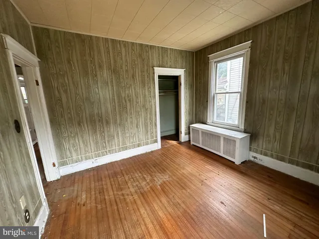 a view of a room with wooden floor and windows