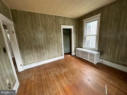 a view of a room with wooden floor and window