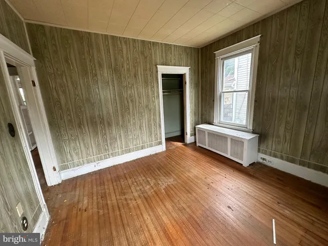a view of a room with wooden floor and window