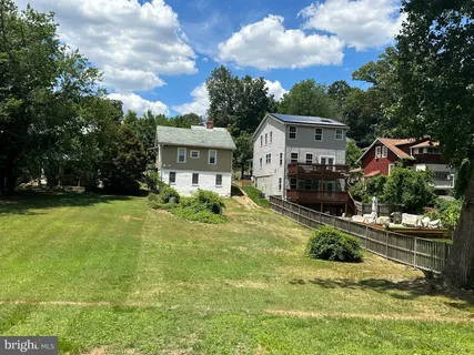 a front view of a house with a yard table and chairs