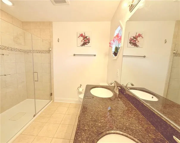 a view of a yard with plants and large trees