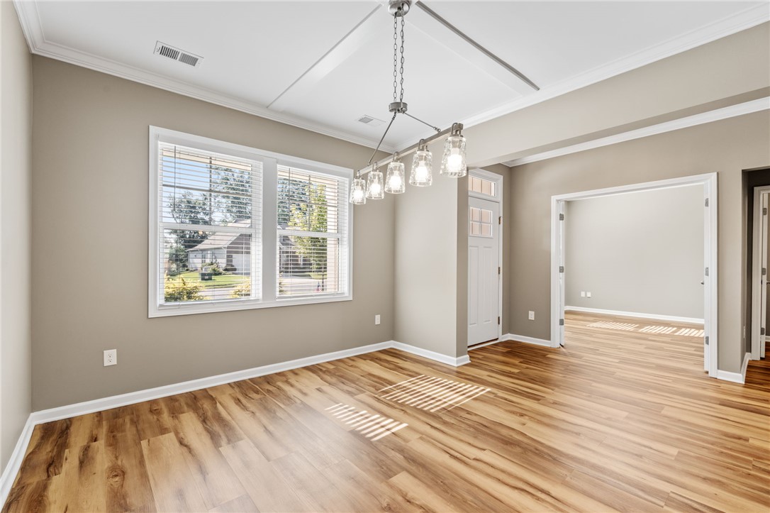 127 Spyglass Lane Pendleton, SC 29670 - Photo 11 of 45 Rich wood floors and elegant crown molding define this open dining area.