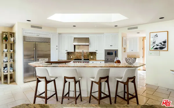 a dining room with furniture a chandelier and wooden floor