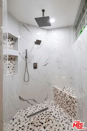 a spacious bedroom with a bed and wooden floor