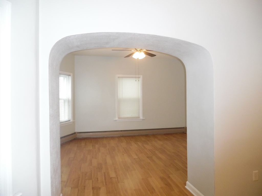 1226 North Main Street, Unit 1 Fall River, MA 02720 - Photo 2 of 10 a view of a small space with wooden floor and a window