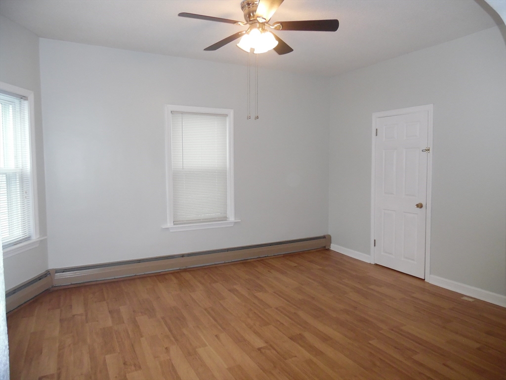 1226 North Main Street, Unit 1 Fall River, MA 02720 - Photo 3 of 10 a view of an empty room with wooden floor and a window
