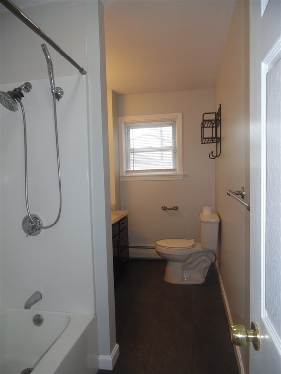 1226 North Main Street, Unit 1 Fall River, MA 02720 - Photo 9 of 10 a bathroom with a granite countertop shower a toilet and a shower