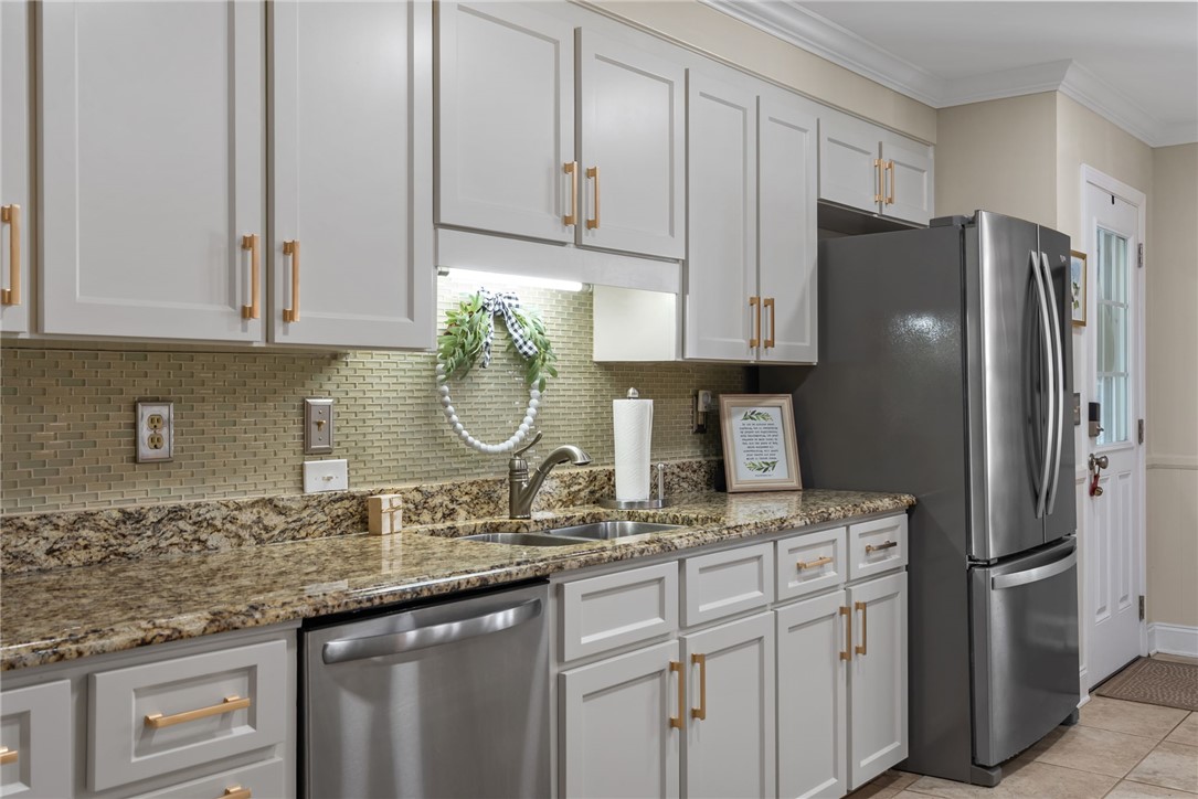 3513 Hopewell Road Anderson, SC 29621 - Photo 29 of 50 A well-appointed kitchen features ample white cabinetry, granite counters, and stainless steel appliances.