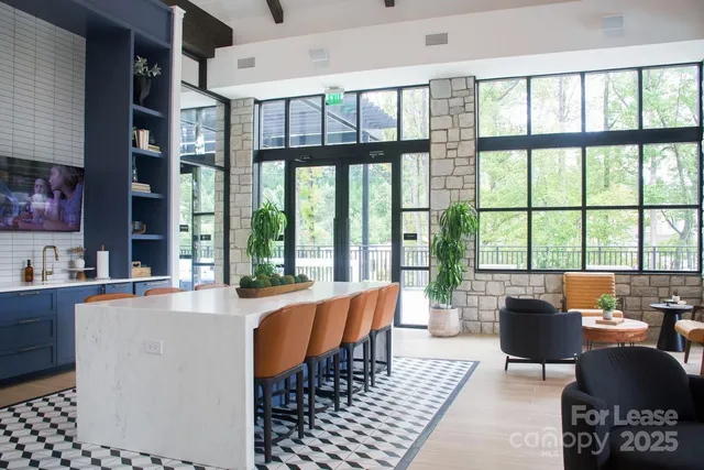 a living room with furniture and large windows