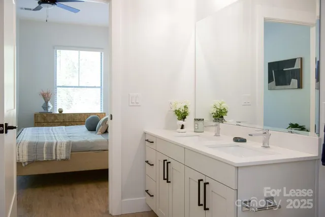 a kitchen with stainless steel appliances a stove a sink a refrigerator a center island and chairs