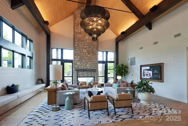a living room with furniture a chandelier and a table