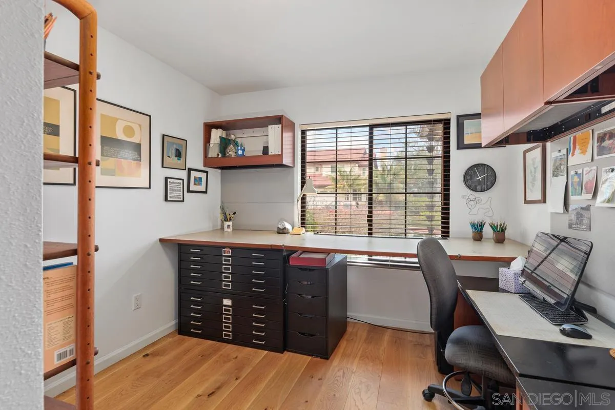 2206 Summerhill Drive Encinitas, CA 92024 - Photo 11 of 33 a view of a kitchen with stainless steel appliances granite countertop a stove a sink dishwasher and a dining table with wooden cabinet