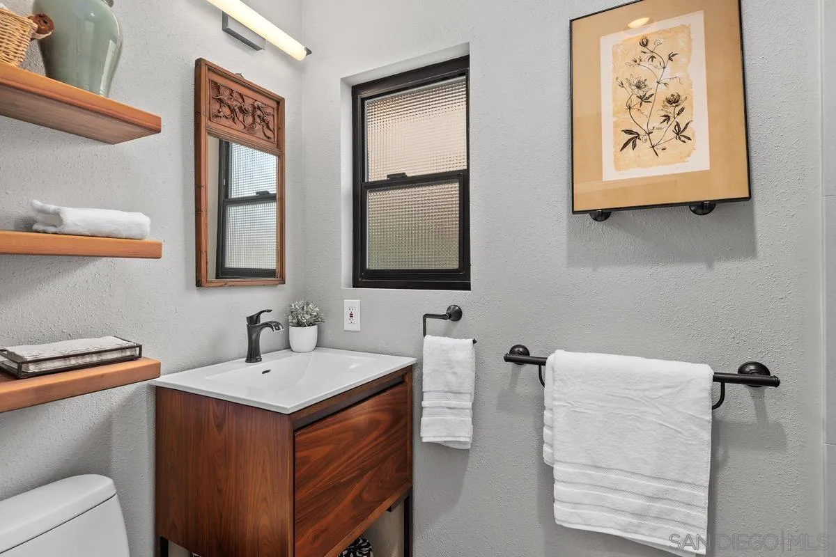 2206 Summerhill Drive Encinitas, CA 92024 - Photo 12 of 33 a bathroom with a sink and a mirror