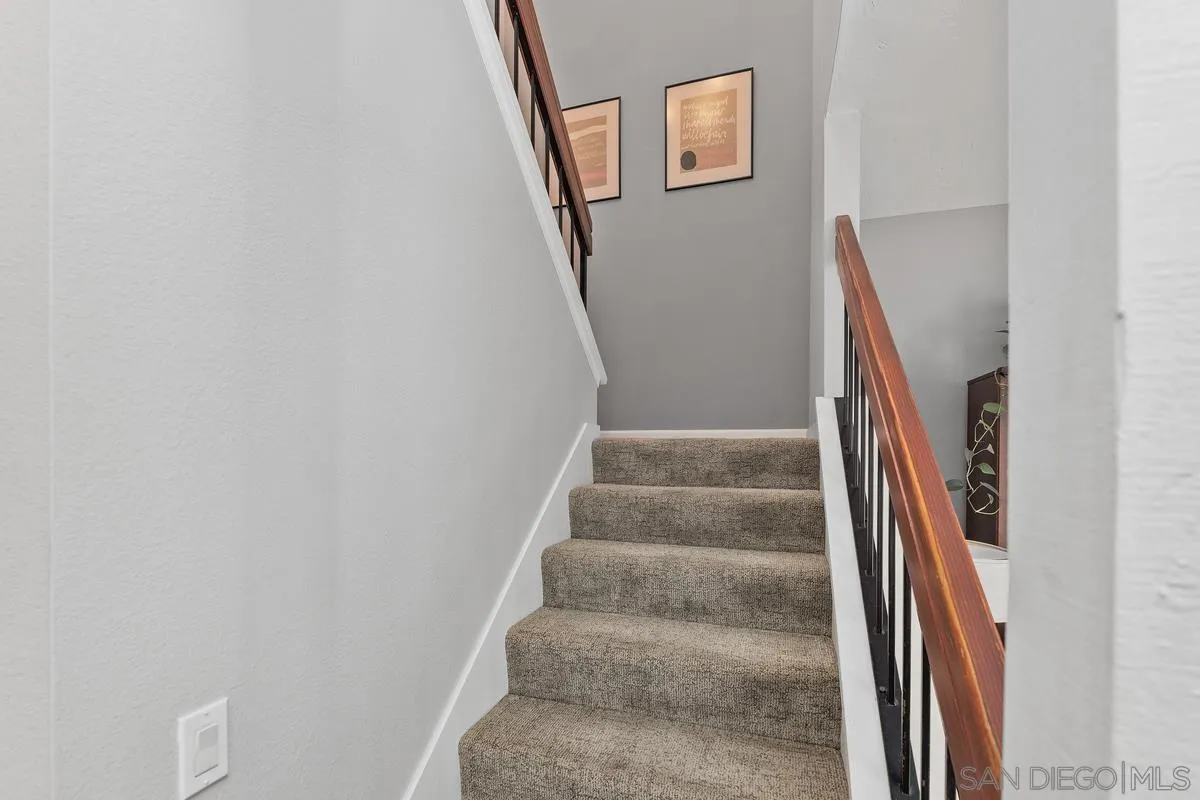 2206 Summerhill Drive Encinitas, CA 92024 - Photo 20 of 33 a view of staircase with wooden floor and white walls