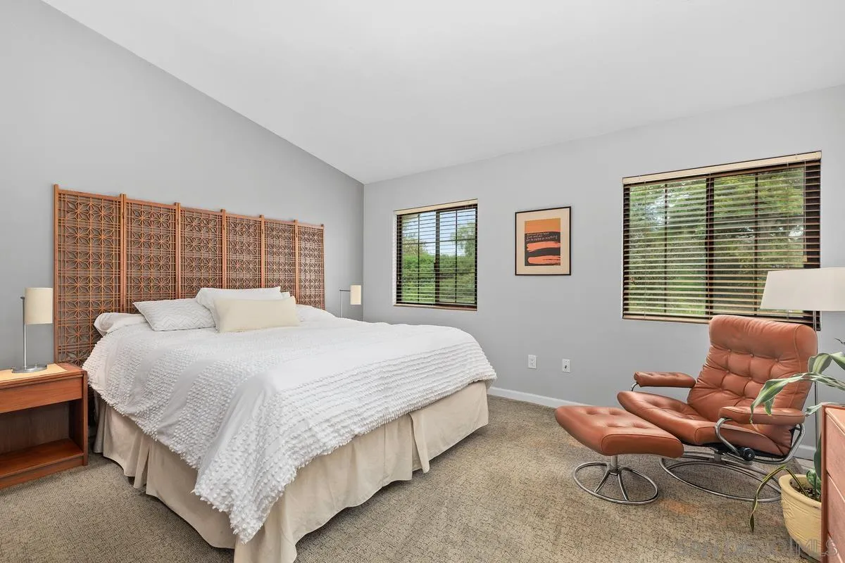 2206 Summerhill Drive Encinitas, CA 92024 - Photo 22 of 33 a bedroom with a bed chair and a window