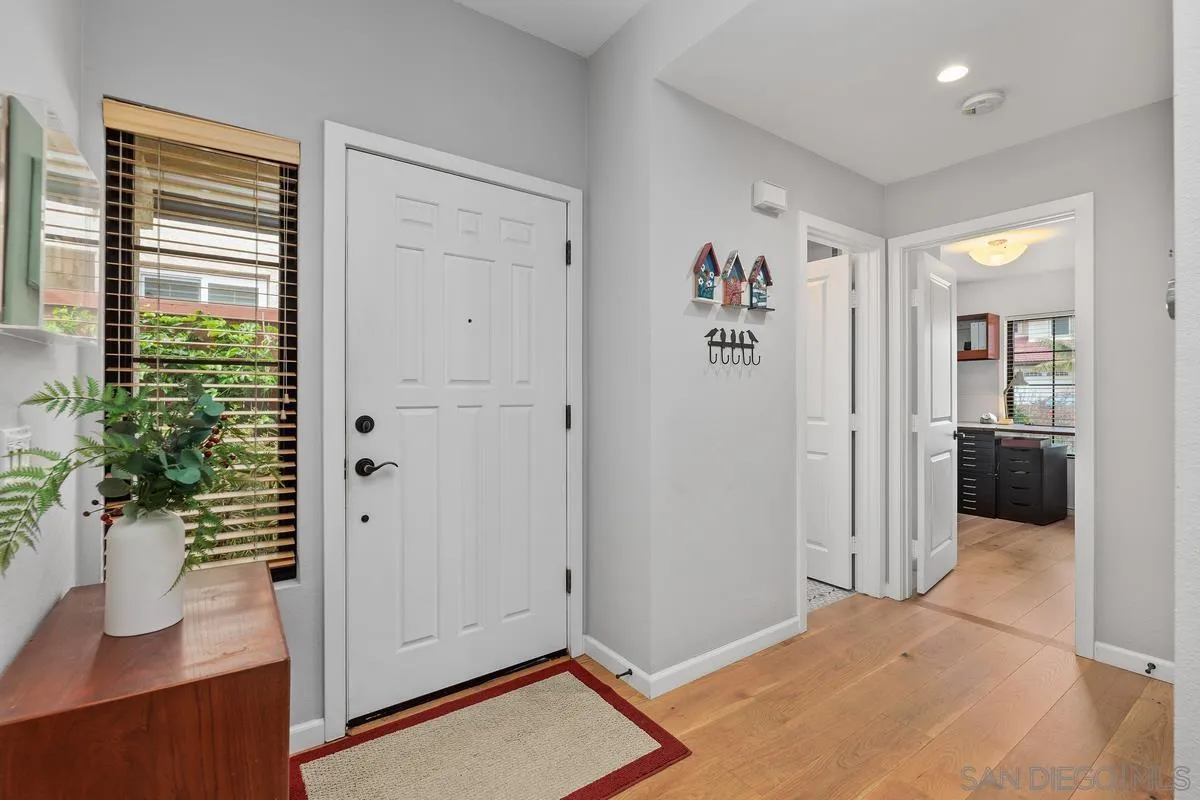 2206 Summerhill Drive Encinitas, CA 92024 - Photo 10 of 33 a view of a bedroom with wooden floor and windows
