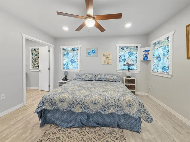 a bedroom with a large bed and a window