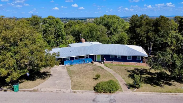 an aerial view of a house with a yard
