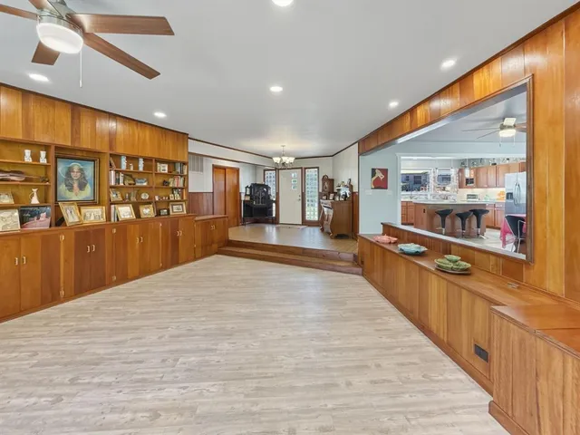 a large kitchen with stainless steel appliances granite countertop plenty wooden cabinets counter top and a stove