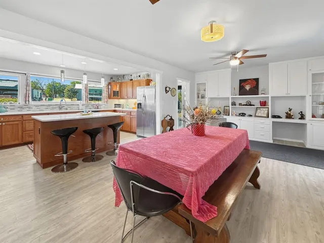 a room with kitchen island a table and chair in it