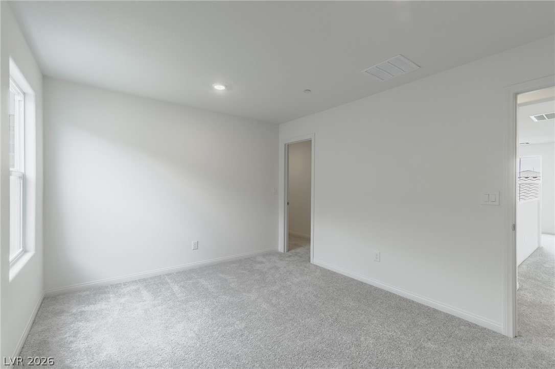 3765 Osiris Avenue Henderson, NV 89044 - Photo 11 of 40 Unfurnished room with light carpet, plenty of natural light, and recessed lighting