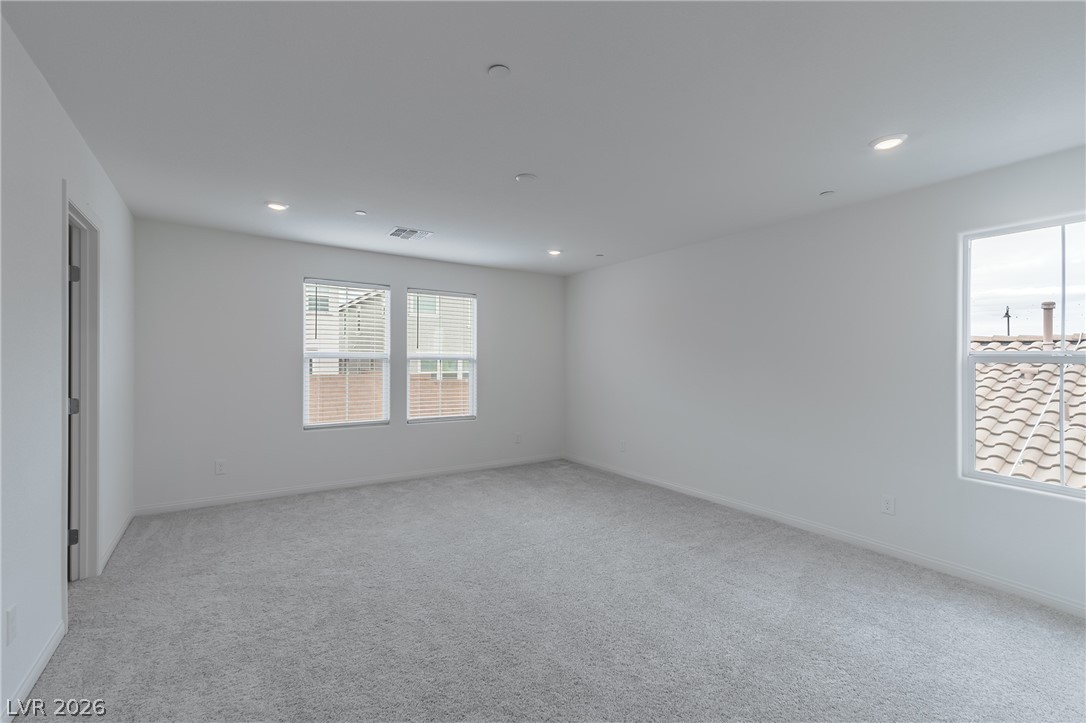 3765 Osiris Avenue Henderson, NV 89044 - Photo 12 of 40 Unfurnished room with light colored carpet and recessed lighting