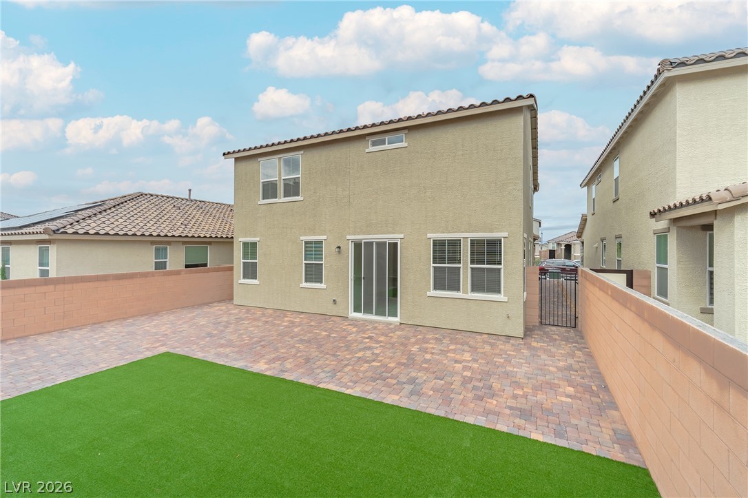 3765 Osiris Avenue Henderson, NV 89044 - Photo 16 of 40 Rear view of property featuring stucco siding, a fenced backyard, and a patio