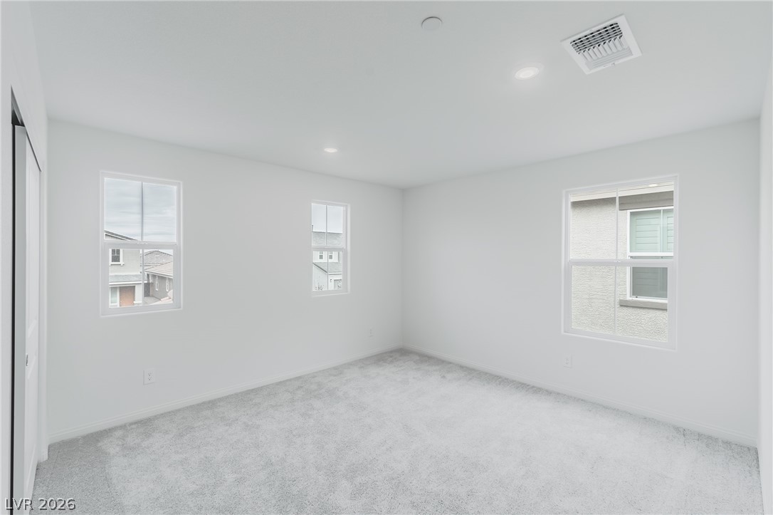 3765 Osiris Avenue Henderson, NV 89044 - Photo 2 of 40 Spare room featuring light carpet, plenty of natural light, and recessed lighting
