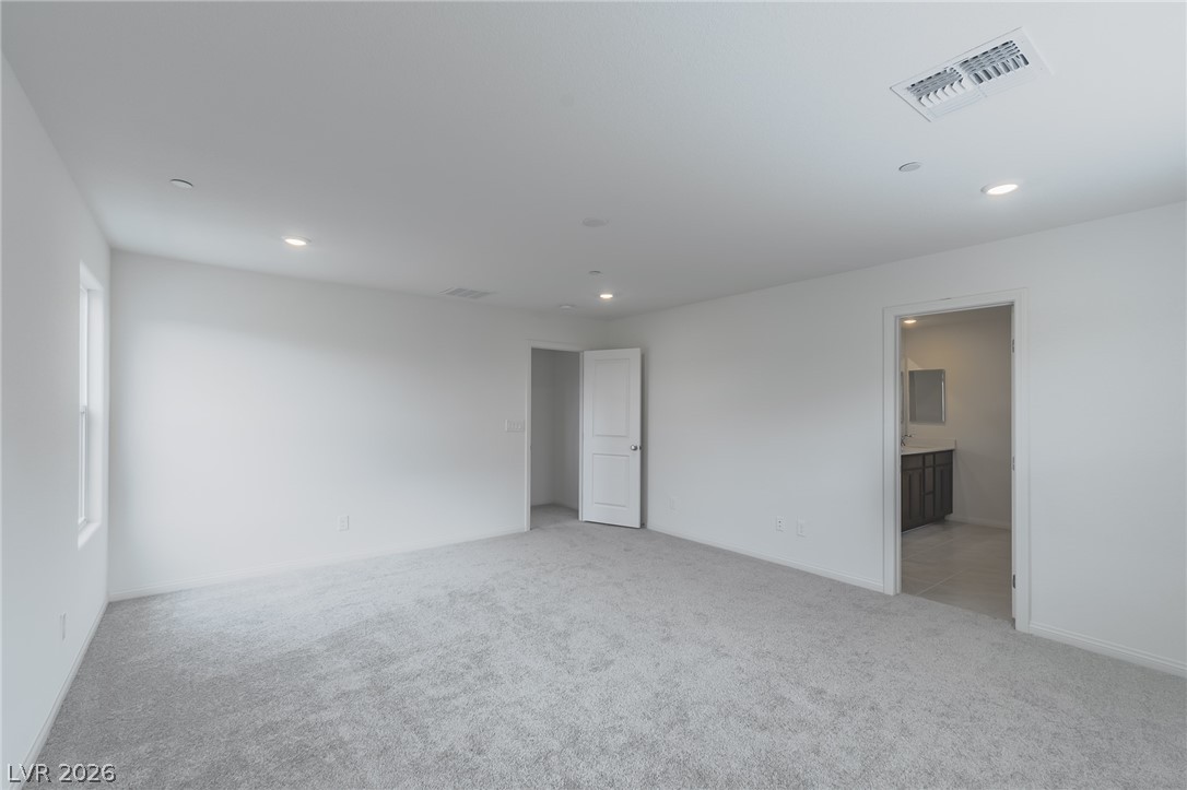 3765 Osiris Avenue Henderson, NV 89044 - Photo 26 of 40 Unfurnished bedroom featuring light carpet, recessed lighting, and ensuite bath