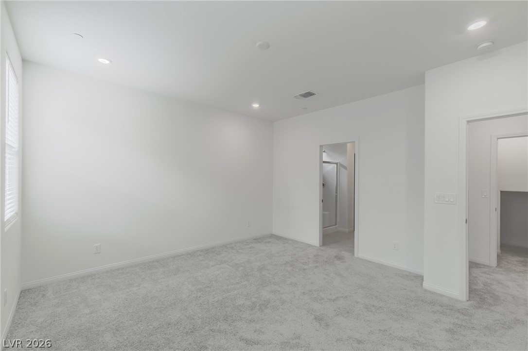 3765 Osiris Avenue Henderson, NV 89044 - Photo 29 of 40 Unfurnished bedroom featuring light colored carpet, recessed lighting, and ensuite bath