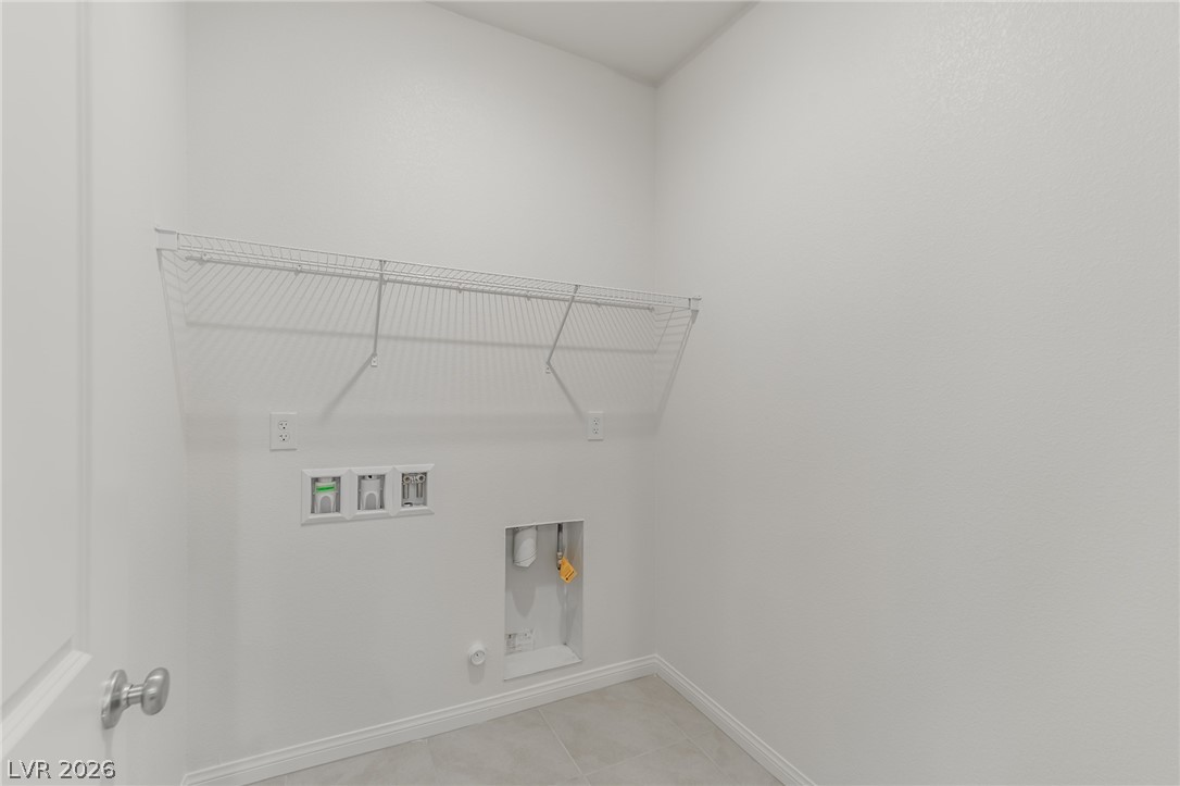 3765 Osiris Avenue Henderson, NV 89044 - Photo 31 of 40 Laundry area with hookup for a gas dryer, hookup for a washing machine, and light tile patterned floors