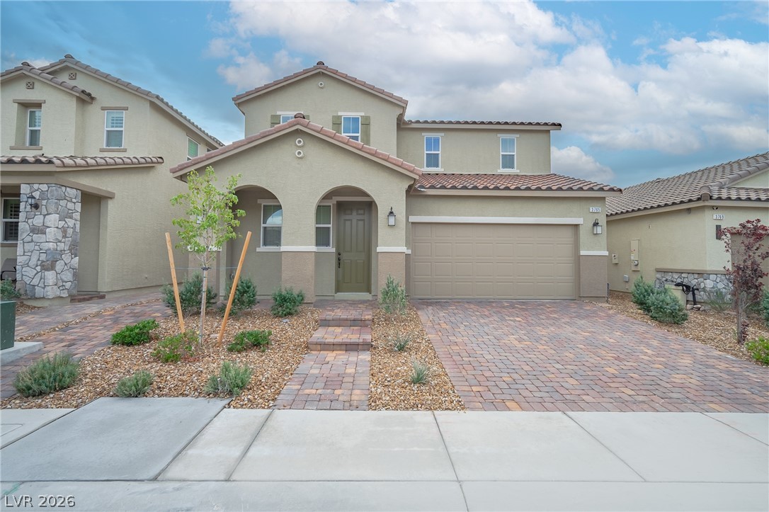 3765 Osiris Avenue Henderson, NV 89044 - Photo 10 of 40 Mediterranean / spanish home featuring stucco siding, decorative driveway, and a tiled roof