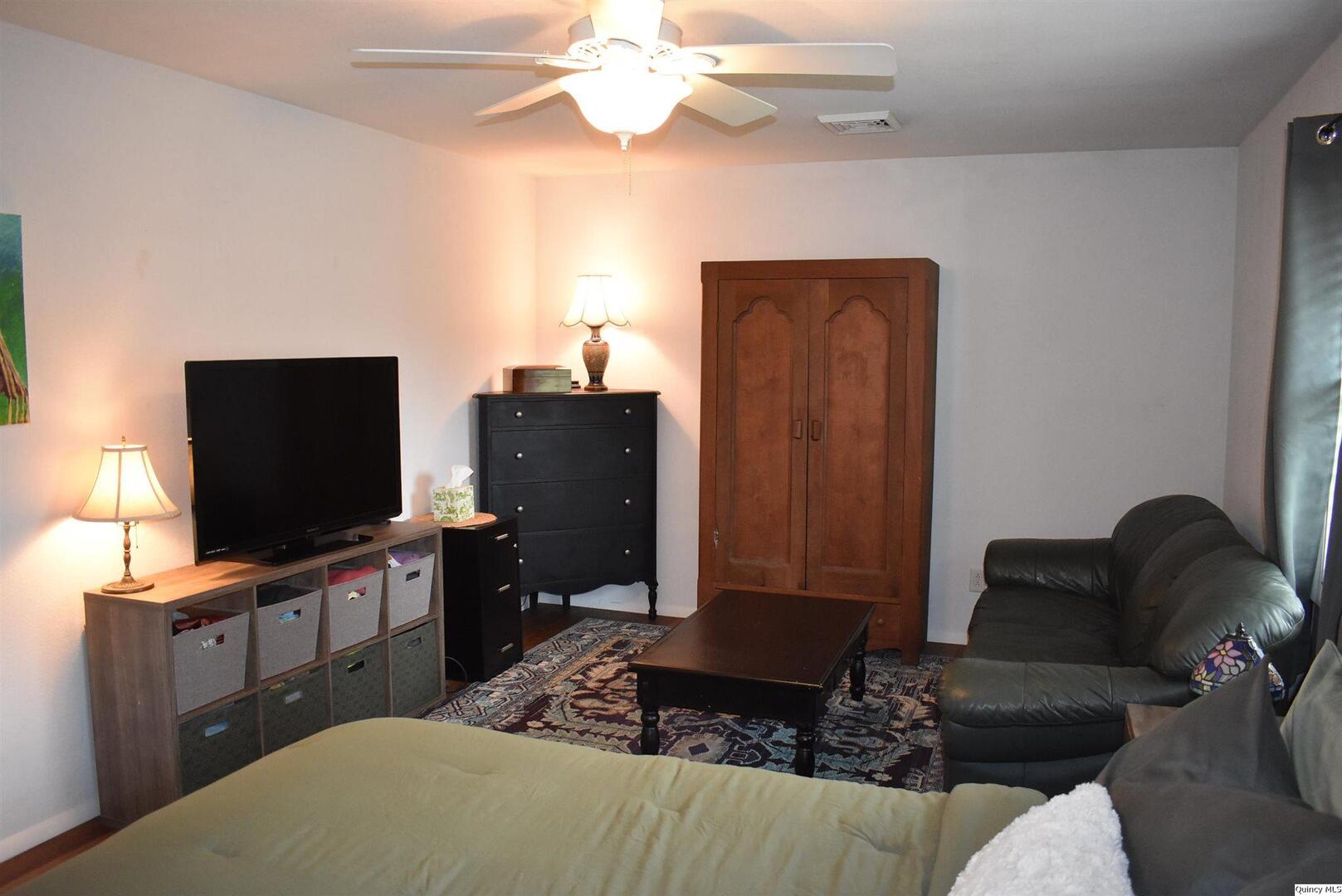 2319 Waters Court Quincy, IL 62301 - Photo 13 of 17 a living room with furniture and a flat screen tv
