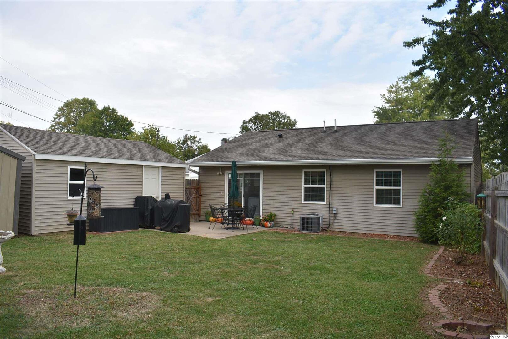 2319 Waters Court Quincy, IL 62301 - Photo 2 of 17 a backyard of a house with table and chairs