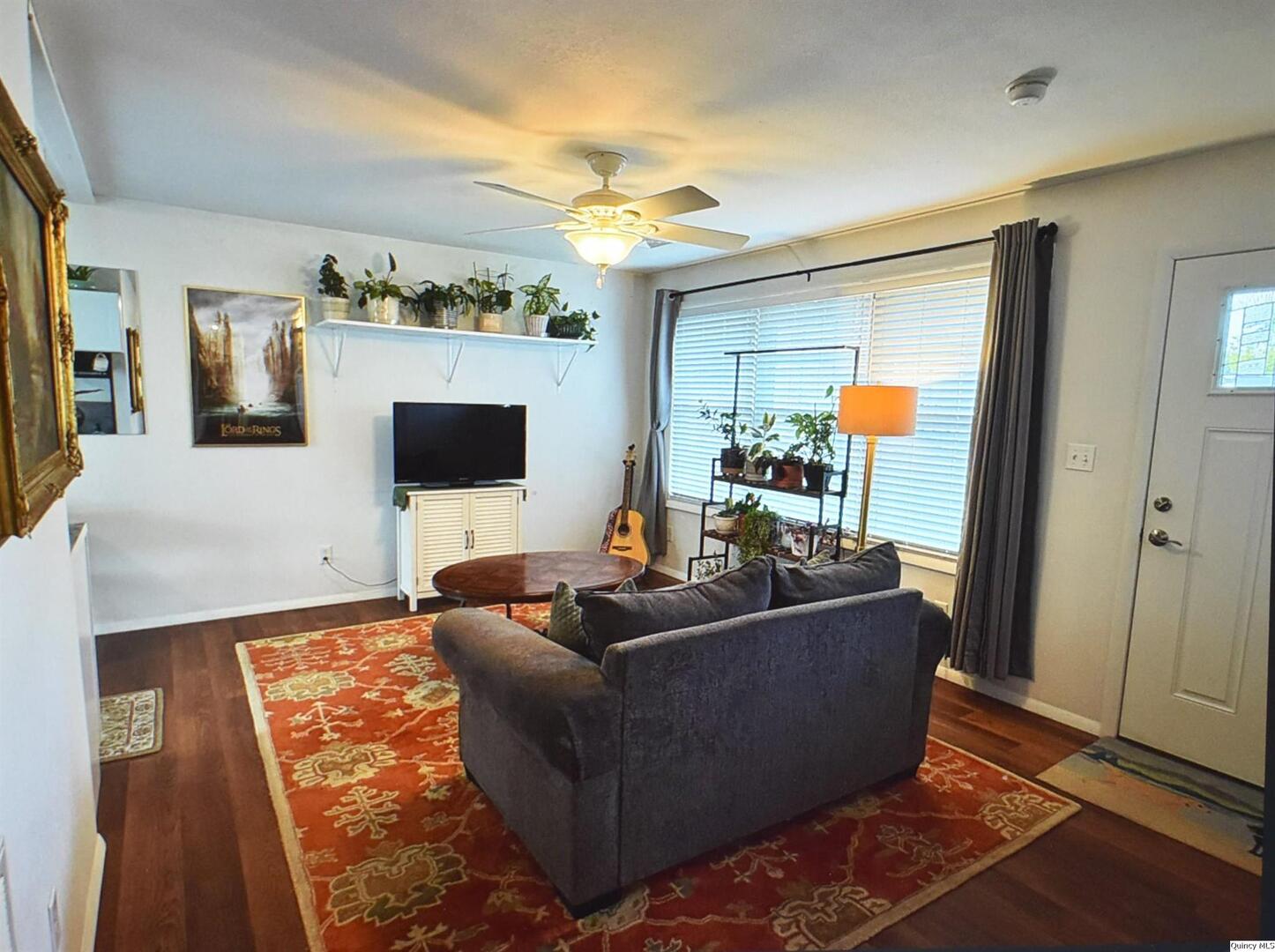 2319 Waters Court Quincy, IL 62301 - Photo 6 of 17 a living room with furniture and a flat screen tv