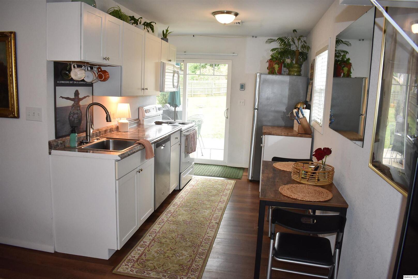 2319 Waters Court Quincy, IL 62301 - Photo 8 of 17 a kitchen with a sink stove and refrigerator