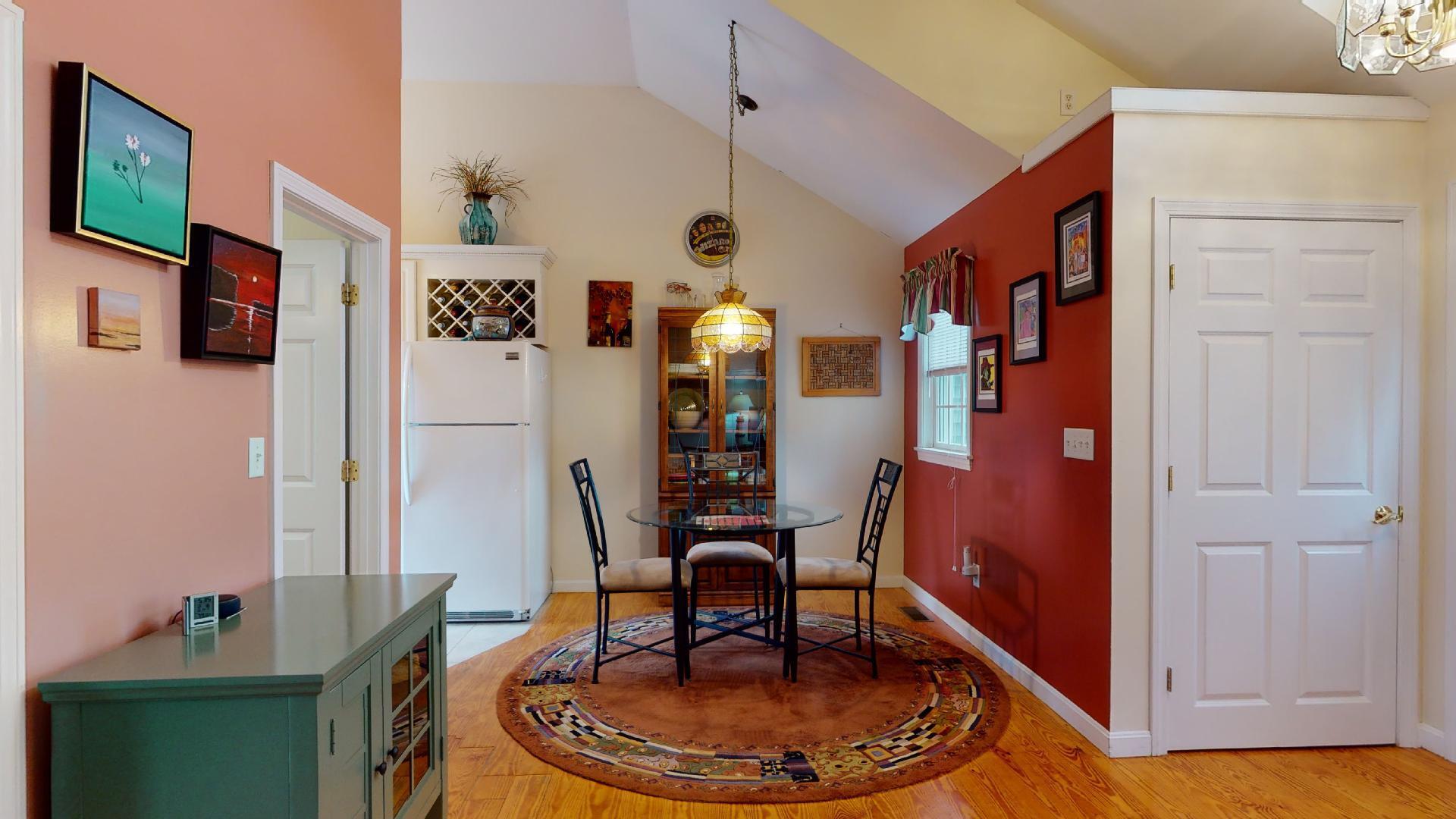 6 Shore Road, Unit 24 Truro, MA 02666 - Photo 17 of 46 a dining room with furniture and wooden floor
