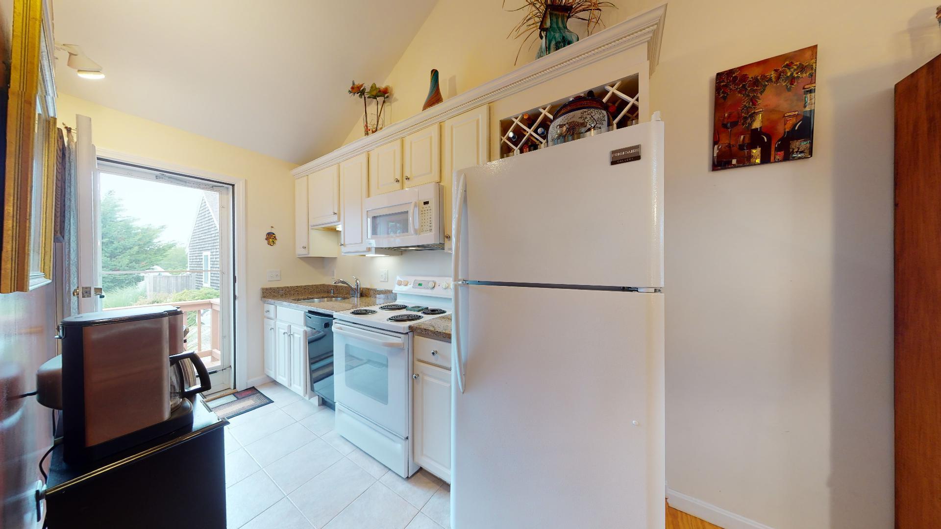 6 Shore Road, Unit 24 Truro, MA 02666 - Photo 22 of 46 a kitchen with a refrigerator and a stove