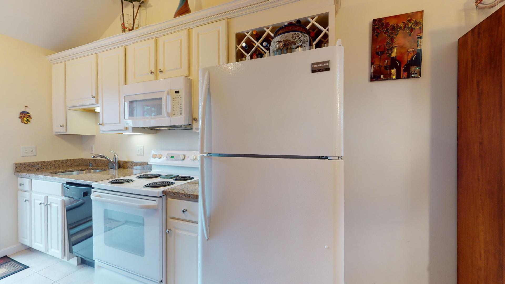 6 Shore Road, Unit 24 Truro, MA 02666 - Photo 28 of 46 a white refrigerator freezer sitting inside of a kitchen