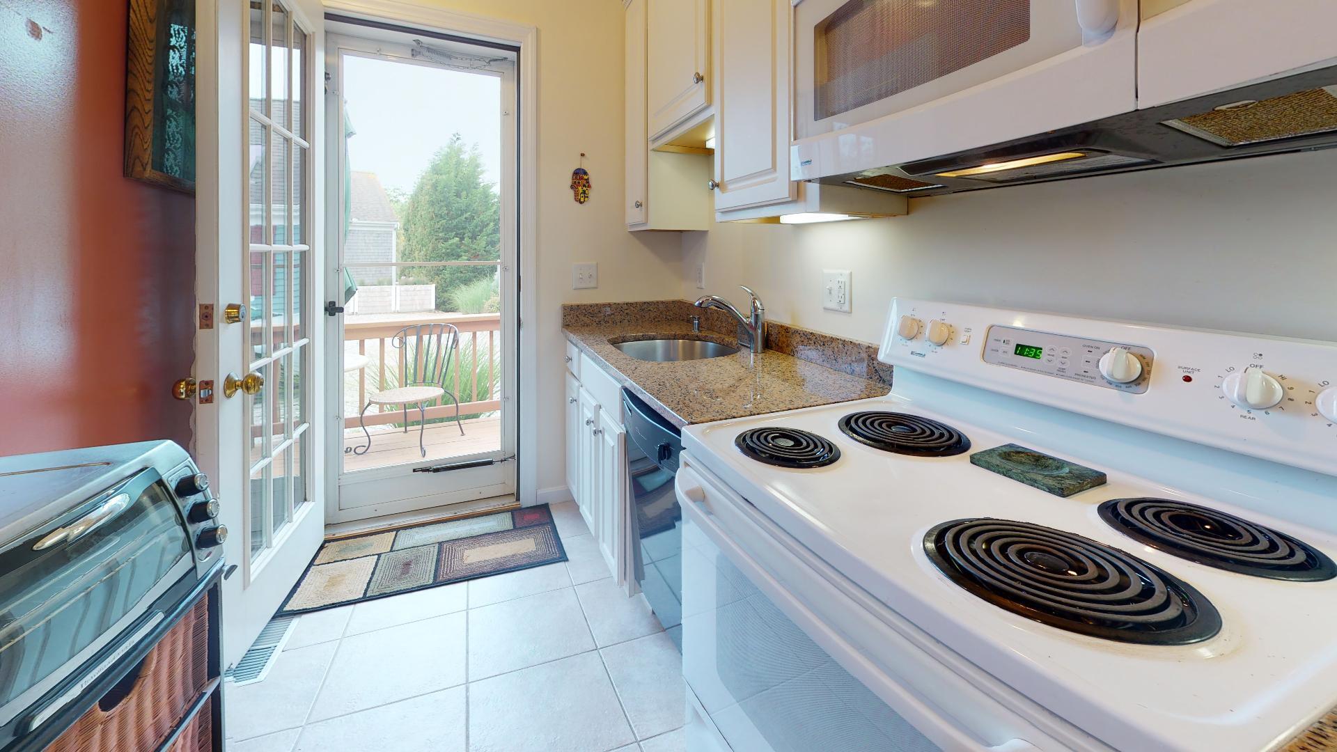 6 Shore Road, Unit 24 Truro, MA 02666 - Photo 29 of 46 a kitchen with a stove and a white refrigerator