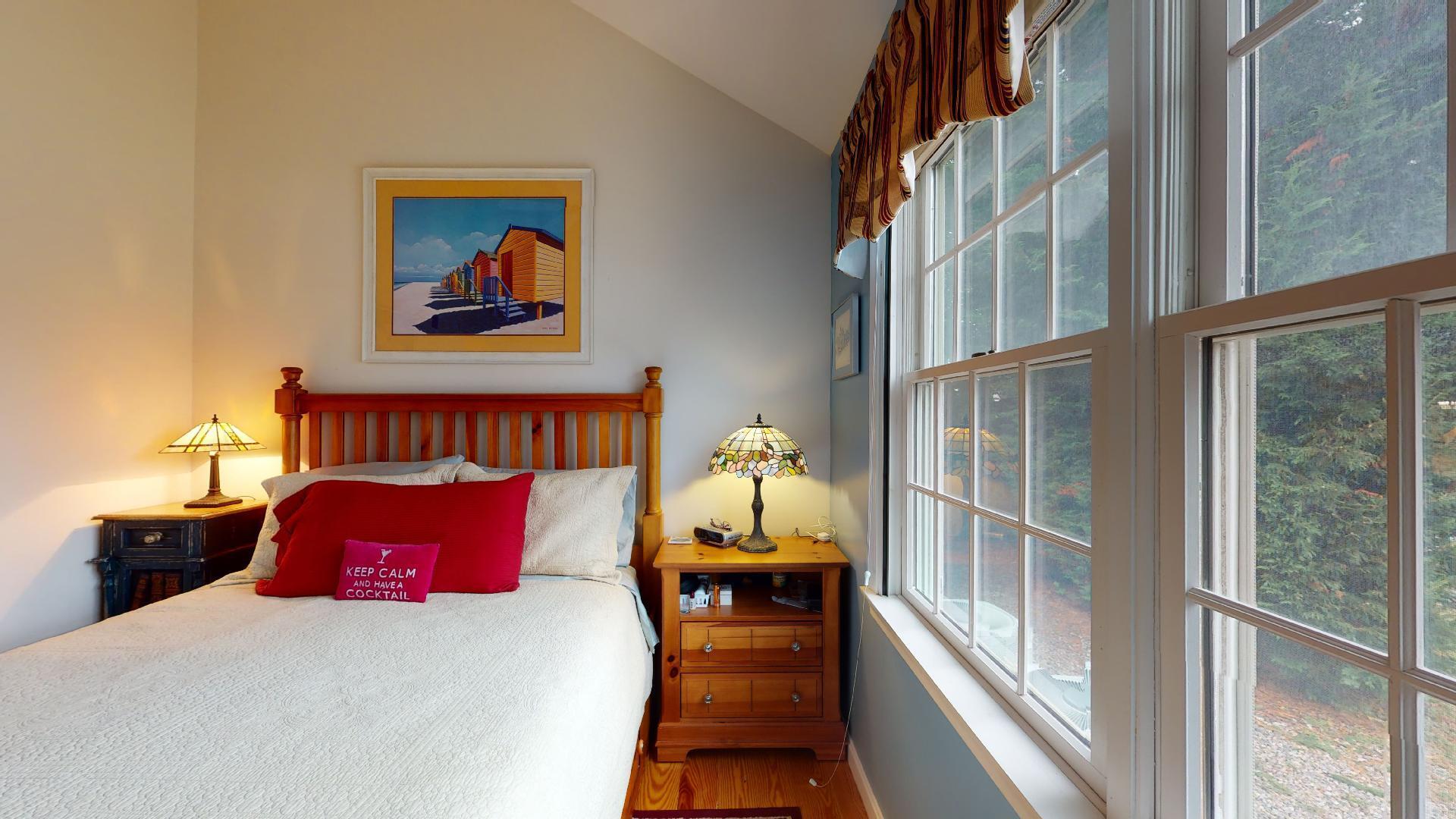 6 Shore Road, Unit 24 Truro, MA 02666 - Photo 33 of 46 a bedroom with a bed and a large window