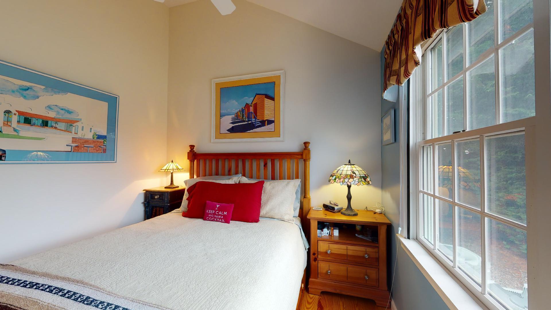 6 Shore Road, Unit 24 Truro, MA 02666 - Photo 36 of 46 a bedroom with a bed and wooden floor