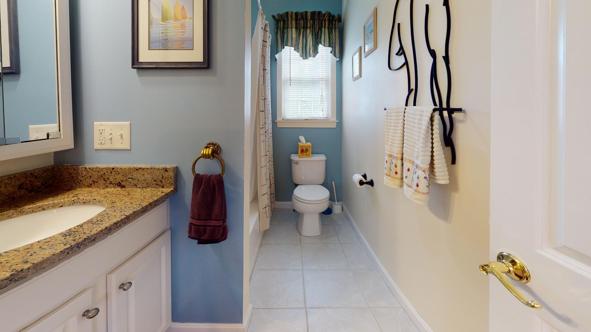 6 Shore Road, Unit 24 Truro, MA 02666 - Photo 39 of 46 a bathroom with a granite countertop sink a toilet and shower