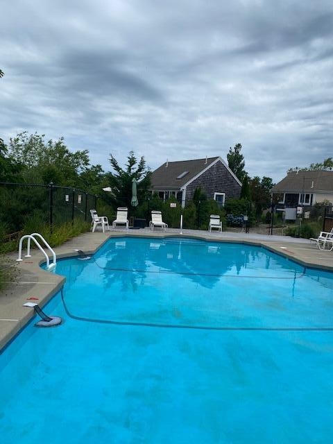 6 Shore Road, Unit 24 Truro, MA 02666 - Photo 45 of 46 a view of a swimming pool with an outdoor seating and hardwood